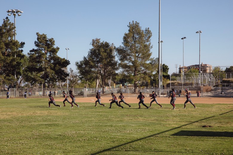 A softball game at Frisbie Park in Rialto on April 18, 2024. Photo by Zaydee Sanchez for CalMatters