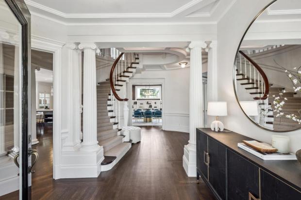 Two-story foyer with grand staircase.