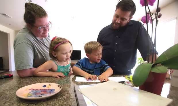 Couple Steven and Katherine Wolf with their daughter Rebekah, 4, look over Everett's, 6, reading project. (Alex Horvath/Los Angeles Times/TNS)