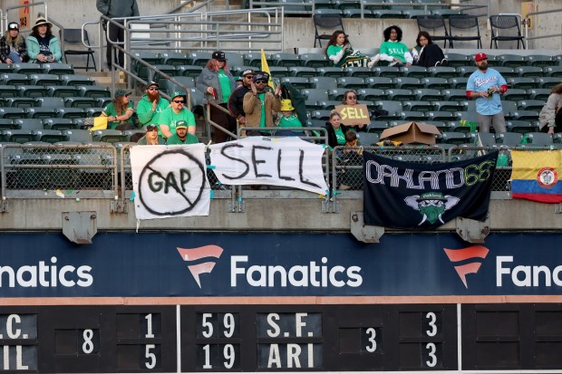 Fans hold signs in the right field bleachers during a game against the Texas Rangers asking Oakland Athletics owner John Fisher to sell the team, Friday, May 12, 2023, in Oakland, Calif. (Karl Mondon/Bay Area News Group)