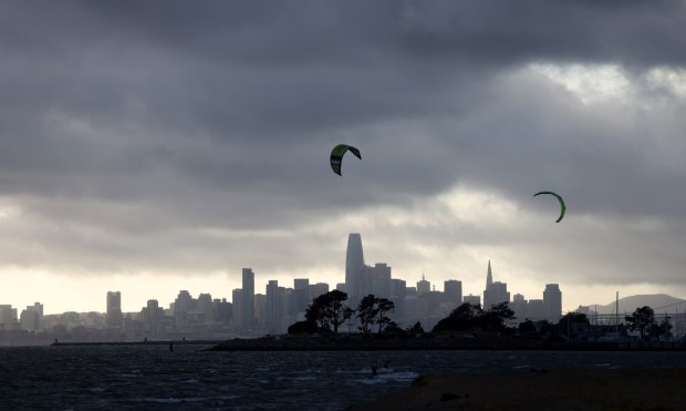 Dark clouds are seen over the San Francisco skyline as kiteboarders take advantage of windy conditions at Robert W. Crown Memorial State Beach in Alameda, Calif., on Monday, May 1, 2023. (Jane Tyska/Bay Area News Group)