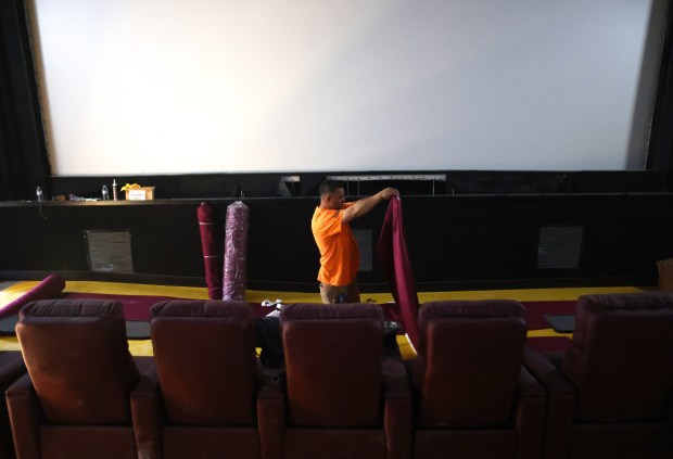 A worker lays out curtains inside the Delta Theater on Wednesday, May 8, 2024, in Brentwood, Calif. The two screen theater is undergoing renovations and is scheduled to open Memorial Day weekend. (Aric Crabb/Bay Area News Group)