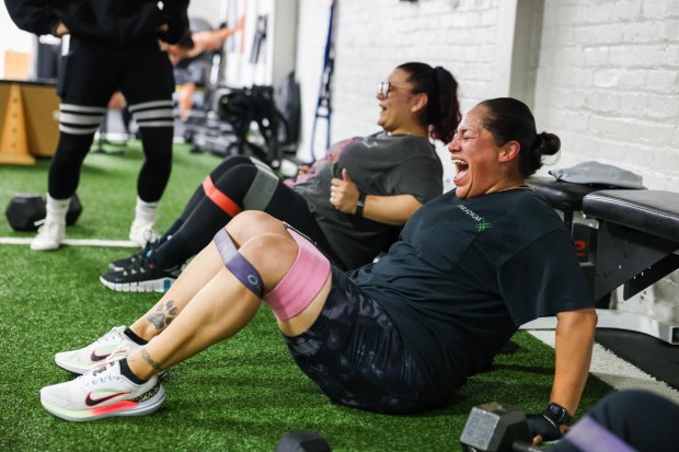 Erika Yanez, of Pinole, reacts as she makes banded seated abductions during a fitness class at Jenuine Fitness in San Pablo, Calif., on Tuesday, May 7, 2024. Jenuine Fitness owner and coach Jennifer Hernando is celebrating five years since her gym was founded. (Ray Chavez/Bay Area News Group)