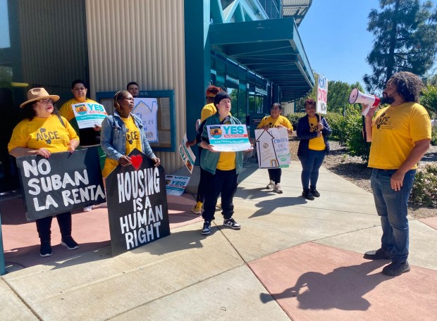 Richmond City Councilman and housing advocate Melvin Willis, at right, speaks with Pittsburg residents and members of the Alliance of Californians for Community Empowerment who delivered some 4,100 signatures to the Pittsburg city clerk on Wednesday, May8, 2024. They were rallying in front of city hall in their campaign to bring rent stabilization, just cause eviction rules and tenant protections to the Nov. ballot.  (Judith Prieve/Bay Area News Group).