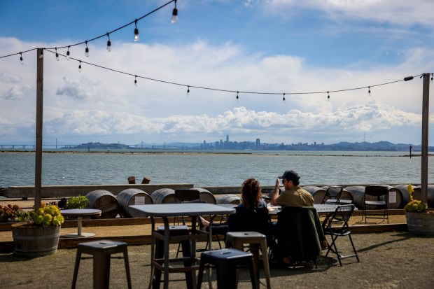 Patrons enjoy wine and view of the San Francisco Bay from the Riggers Loft Wine Company in Richmond, Calif., on Saturday, March 30, 2024. (Ray Chavez/Bay Area News Group)