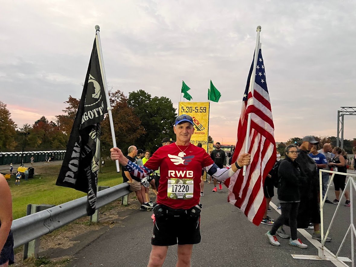 guy with POW and American flag at MCM marine corps race.jpg