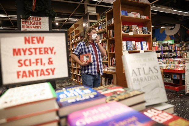 Scott Shafer, an employee from Menlo Park, organizes books at Kepler's Books in Menlo Park, Calif., on Saturday, Nov. 19, 2022. (Shae Hammond/Bay Area News Group)