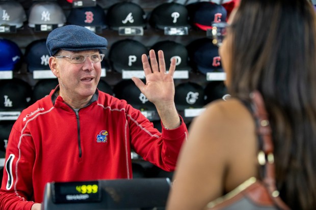 Jeff Fingerut, third generation owner of West Coast Sporting Goods, checks the hand size of Lanae Poe, a softball player shopping for batting gloves, Saturday, Feb. 18, 2023, in San Leandro, Calif. (Karl Mondon/Bay Area News Group)