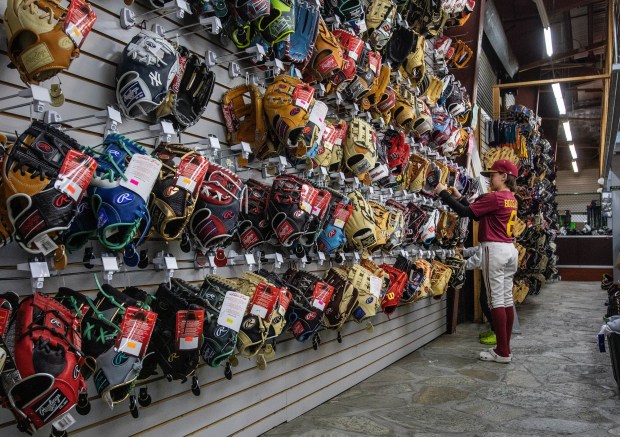 A young baseball player shops for a baseball glove at West Coast Sporting Goods in San Leandro, Calif., Saturday, Feb. 18, 2023. (Karl Mondon/Bay Area News Group)