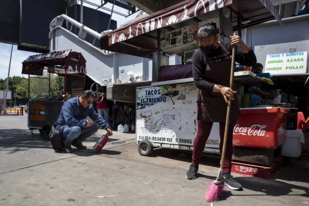 Manuel Antonio Hernández Lugo, an inspector at the San Ysidro border gate, verifies street vendors' booths on July 17, 2023. (Ana Ramírez/The San Diego Union-Tribune)