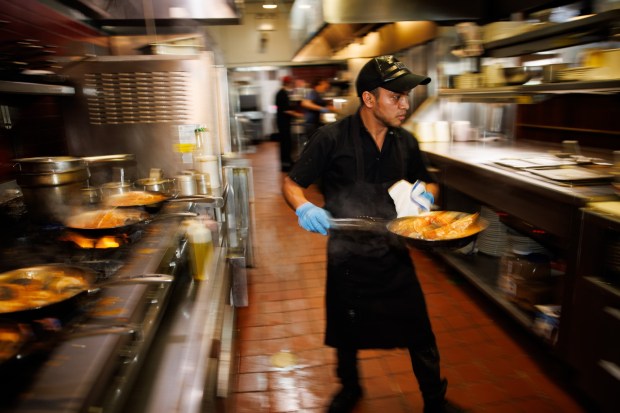 On the last day of service at The Fish Market in Palo Alto, Calif., Marvin Coc, a cook at the restaurant, prepares seafood dishes on Wednesday, Sept. 13, 2023. After 47 years, the seafood restaurant chain is closing two Northern California locations in Palo Alto and San Mateo. Today is the last day of the Palo Alto location. The last day of the San Mateo location is Sept. 20. (Dai Sugano/Bay Area News Group)