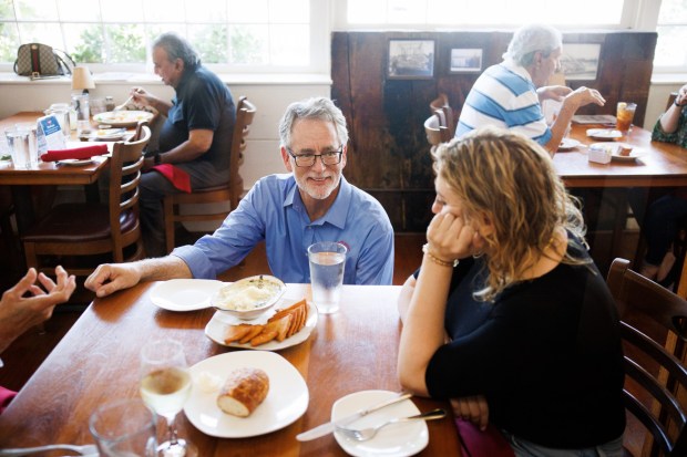 On the last day of service at The Fish Market in Palo Alto, Calif., Dwight Colton, the president of the Fish Market restaurants, talks with long time customers on Wednesday, Sept. 13, 2023. After 47 years, the seafood restaurant chain is closing two Northern California locations in Palo Alto and San Mateo. Today is the last day of the Palo Alto location. The last day of the San Mateo location is Sept. 20. (Dai Sugano/Bay Area News Group)