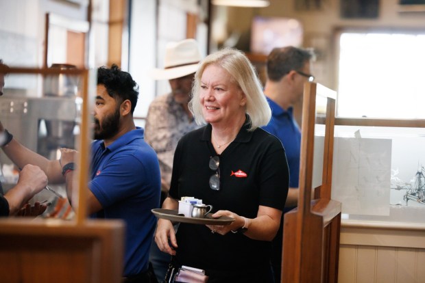 On the last day of service at The Fish Market in Palo Alto, Calif., Lyla Phelps, who has worked in the restaurant since 1980, interacts with co-workers on Wednesday, Sept. 13, 2023. After 47 years, the seafood restaurant chain is closing two Northern California locations in Palo Alto and San Mateo. Today is the last day of the Palo Alto location. The last day of the San Mateo location is Sept. 20. (Dai Sugano/Bay Area News Group)