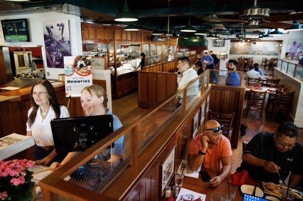 On the last day of service at The Fish Market in Palo Alto, Calif., hosts at the restaurant, Kathy Tweed, left, and Kirsty Milne, greet customers on Wednesday, Sept. 13, 2023. After 47 years, the seafood restaurant chain is closing two Northern California locations in Palo Alto and San Mateo. Today is the last day of the Palo Alto location. The last day of the San Mateo location is Sept. 20. (Dai Sugano/Bay Area News Group)