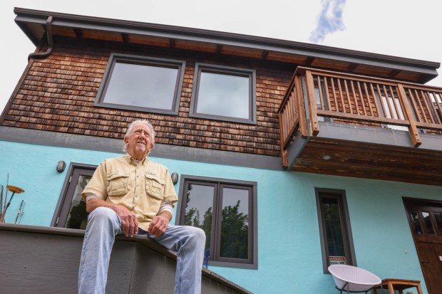 Mike Bradley, 83, sits in front of his ADU his son Casey built in the same lot in Berkeley, Calif., on Friday, May 24, 2023. (Ray Chavez/Bay Area News Group)