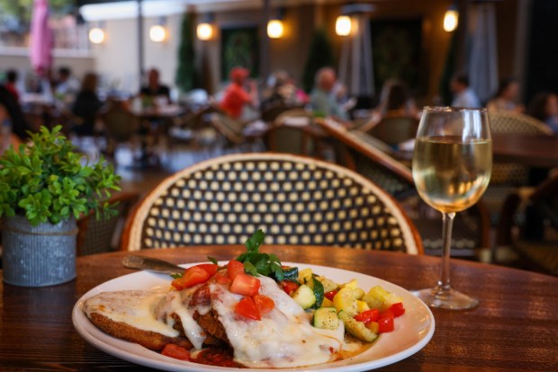 Eggplant Parmesan is served as patrons dine out in the patio at Giorgio's Italian restaurant in Morgan Hill, Calif., on Wednesday, July 27, 2023. (Ray Chavez/Bay Area News Group)