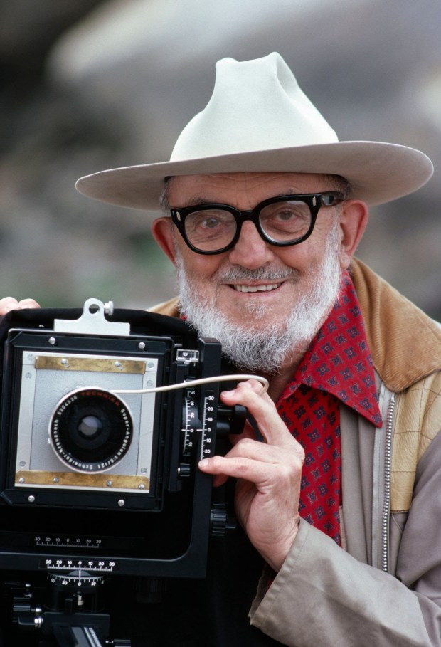 (NO U.S. TABLOID SALES) Legendary photographer Ansel Adams with his large format camera Sept. 3, 1979 in Point Lobos (south of Carmel), California. Adams, born in San Francisco, was a commercial photographer for 30 years. He created photos of western landscapes that were inspired by a trip to Yosemite, California as a child. He won three Guggenheim grants to photograph the national parks (1944--58), served on the board of the Sierra Club (1934-71) and founded the f/64 group with Edward Weston in 1932. Adams passed away April 22, 1984 of heart failure aggravated by cancer. (Credit/David Hume Kennerly/Getty Images)