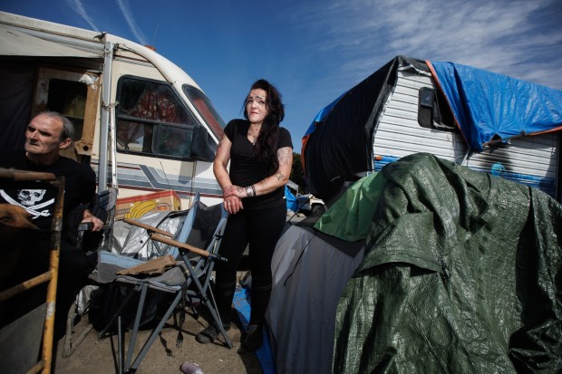 Unhoused resident, Mariena Acosta, center, who lives in a tent at the homeless encampment near Columbus Park in San Jose, talks during an interview on Friday, April 12, 2024. (Dai Sugano/Bay Area News Group)