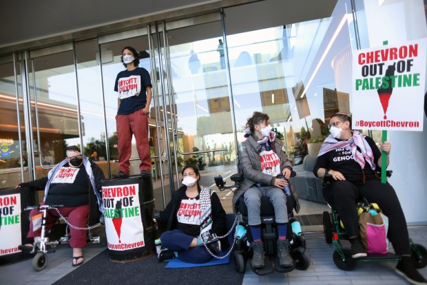 A group of pro-Palestine protesters block an entrance to Chevron offices on Wednesday, May 29, 2024, in San Ramon, Calif. Over 50 protesters gathered at the San Ramon office park to disrupt Chevron's annual shareholder meeting. (Aric Crabb/Bay Area News Group)