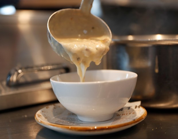 A cup of "Clam Chowder & Warm Bread; clams potatoes, bacon, corn," for $5 from the happy hour menu at Forthright Oyster Bar & Kitchen poured by manager Taylor Ronsvalle in Campbell, Calif., on Sunday, January 14, 2018. (Nhat V. Meyer/Bay Area News Group)