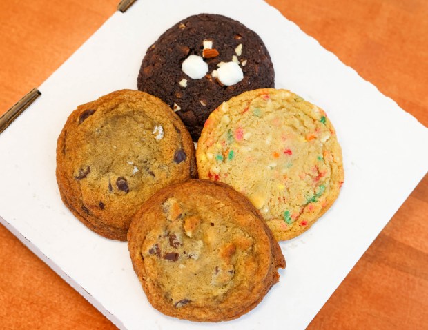 A rocky road cookie, top clockwise, birthday cake, Chunky Monkey and dark chocolate sea salt are some of the variety of cookies customers order at Butter Pecan Bakeshop in Emeryville, Calif., on Friday, April 12, 2024. (Ray Chavez/Bay Area News Group)