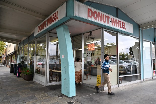 A customer exits the front door of the Donut Wheel in Livermore, Calif., on Monday, Oct. 9, 2023. (Jose Carlos Fajardo/Bay Area News Group)