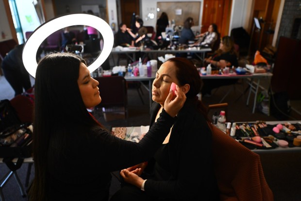 Makeup artist Azucena Ramos applies foundation to Blanca Garibay, of Watsonville, during the Farmworker Caravan Conference and Retreat held at the Saint Francis Retreat Center in San Juan Bautista, Calif., on Sunday, May 19, 2024. Over 50 stylists, barbers and make up artists will gathered today to treat farmworkers to make overs, offering a rare luxury to the largely low-income individuals. This week marks the second time that the event has been held. (Jose Carlos Fajardo/Bay Area News Group)