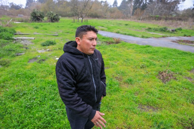 Farm supervisor and mass shooting survivor, Juan Flores Lopez, stands where he used to live at California Terra Garden Farms in Half Moon Bay on a recent Saturday. His neighbors, Jose Perez, was killed and his brother Pedro severely injured by co-worker Chunli Zhao. They all lived in this small neighborhood that has since been demolished. (Ray Chavez/Bay Area News Group)