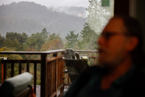 Frank Bauerle looks at his insurance nonrenewal notice at his home in Ben Lomond, Calif., on Friday, March 29, 2024. Frank Bauerle has taken many steps to fireproof his Ben Lomond home, steps that state officials and consumer advocates encourage and promise rewards for those who take the steps. But his insurer, Farmers, discontinued his coverage. (Shae Hammond/Bay Area News Group)