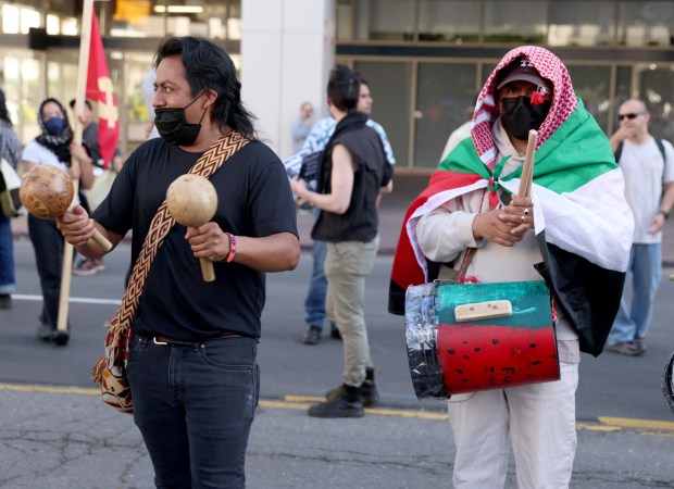 Pro-Palestinian protesters march down 14th Street as they head to a May Day rally at City Hall in downtown Oakland, Calif., on Wednesday, May 1, 2024. Multiple protests took place throughout the Bay Area as part of May Day action in support of workers and Palestinian people. (Jane Tyska/Bay Area News Group)