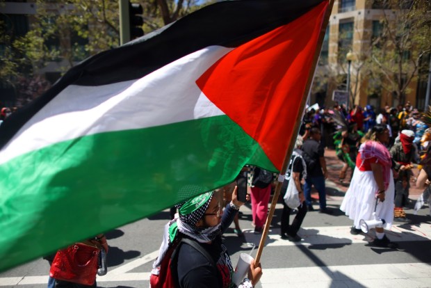 Protesters gather along Clay Street in front of the Ronald V. Dellums Federal Building for a May Day rally on Wednesday, May 1, 2024, in Oakland, Calif. (Aric Crabb/Bay Area News Group)