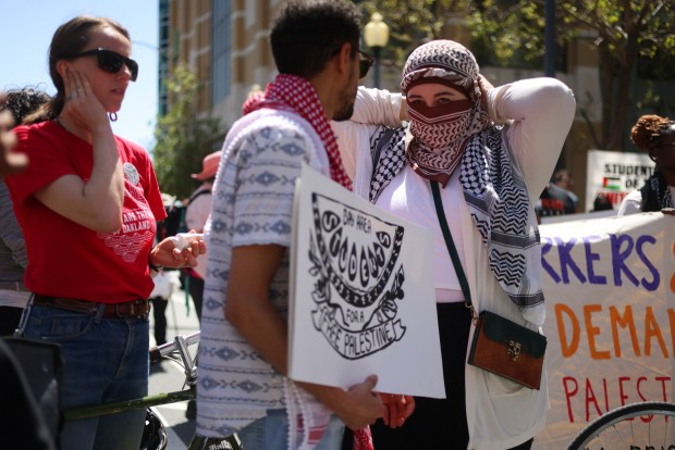 Protesters gather along Clay Street in front of the Ronald V. Dellums Federal Building for a May Day rally on Wednesday, May 1, 2024, in Oakland, Calif. (Aric Crabb/Bay Area News Group)