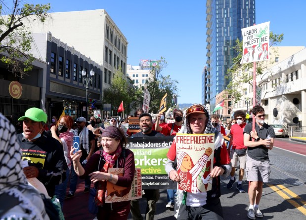 Pro-Palestinian protesters march down Broadway as they head to a May Day rally at City Hall in downtown Oakland, Calif., on Wednesday, May 1, 2024. Multiple protests took place throughout the Bay Area as part of May Day action in support of workers and Palestinian people. (Jane Tyska/Bay Area News Group)