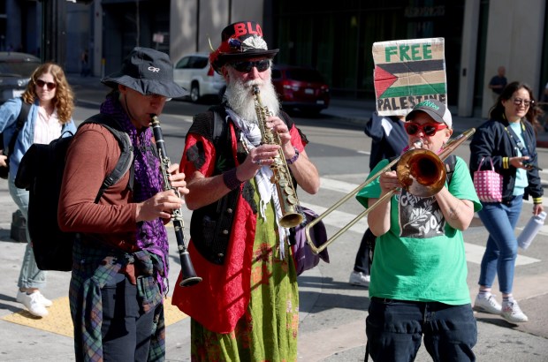 Musicians play as pro-Palestinian protesters march down Broadway as they head to a May Day rally at City Hall in downtown Oakland, Calif., on Wednesday, May 1, 2024. Multiple protests took place throughout the Bay Area as part of May Day action in support of workers and Palestinian people. (Jane Tyska/Bay Area News Group)