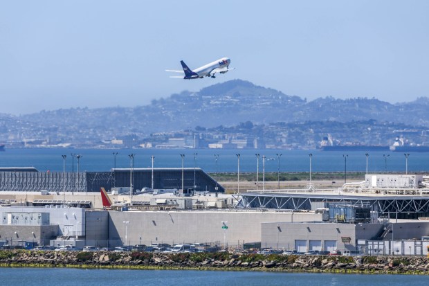 A FedEx airplane departs from the Oakland International Airport seen from San Leandro, Calif., on Thursday, April 11, 2024. (Ray Chavez/Bay Area News Group)