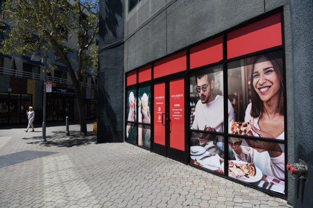 A woman finishes her ice cream as she walks past an empty storefront business at Jack London Square in Oakland, Calif., on Monday, April 29, 2024. Now that the Oakland A's stadium development is unlikely to happen the future is unsure for local businesses in the Oakland waterfront area. (Jose Carlos Fajardo/Bay Area News Group)