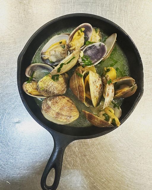 Fresh Clams in a white wine and garlic sauce is one of the Portuguese classics on the Petiscos menu. (Photo courtesy of Petiscos).