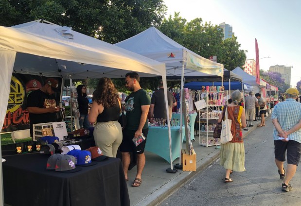 Visitors to the Pobladores Night Market in downtown San Jose walk by vendor booths on South First Street on Thursday, June 6, 2024. (Sal Pizarro/Bay Area News Group)