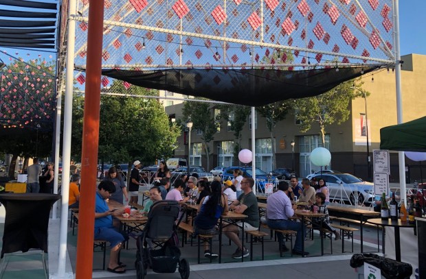 Visitors to the Pobladores Night Market enjoy food truck fare and a beer garden at Parque de los Pobladores in downtown San Jose on Thursday, June 6, 2024. (Sal Pizarro/Bay Area News Group)