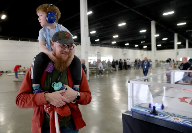 Trevor Charisse and his son Elwood, 3, check out the sights during the RoboGames 2023 competition at the Alameda County Fairgrounds in Pleasanton, Calif., on Thursday, April 6, 2023. Both local and international participants competed in over 40 events at the 16th annual world championship. (Jane Tyska/Bay Area News Group)