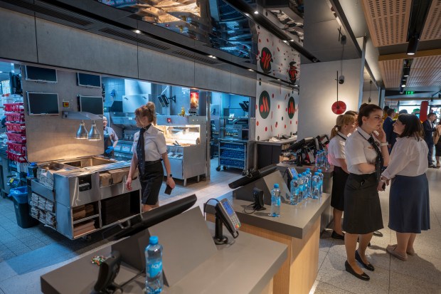 Staff members wait for visitors at a newly opened fast food restaurant in a former McDonald's outlet in Bolshaya Bronnaya Street in Moscow, Russia, Sunday, June 12, 2022. The first of former McDonald's restaurants is reopened with new branding in Moscow. The corporation sold its branches in Russia to one of its local licensees after Russia sent tens of thousands of troops into Ukraine. (AP Photo/Dmitry Serebryakov)