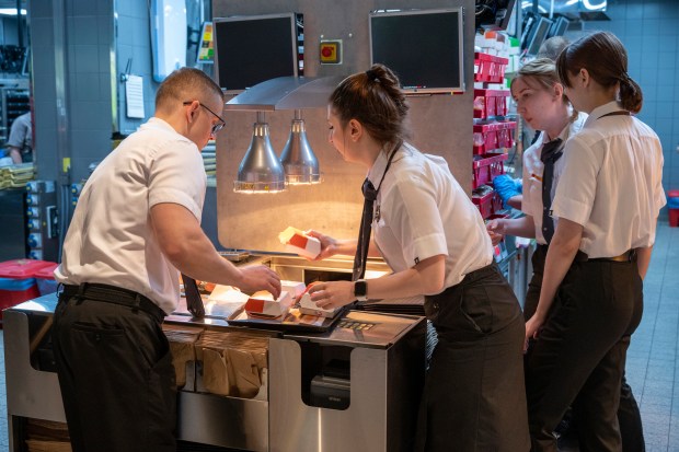 Staff members are at work at a newly opened fast food restaurant in a former McDonald's outlet in Bolshaya Bronnaya Street in Moscow, Russia, Sunday, June 12, 2022. The first of former McDonald's restaurants is reopened with new branding in Moscow. The corporation sold its branches in Russia to one of its local licensees after Russia sent tens of thousands of troops into Ukraine. (AP Photo/Dmitry Serebryakov)