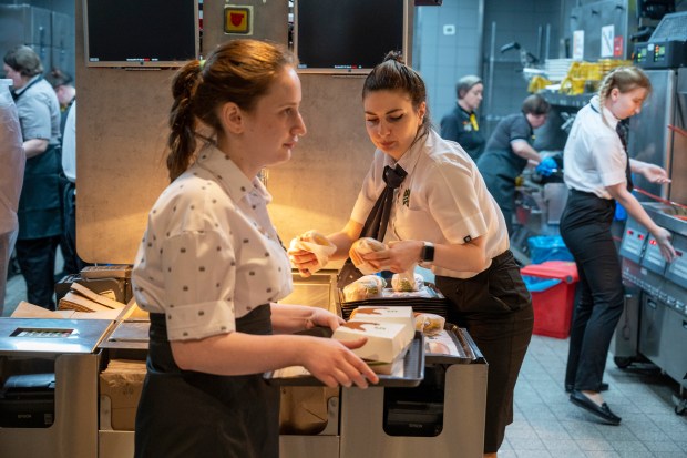 Staff members work at a newly opened fast food restaurant in a former McDonald's outlet in Bolshaya Bronnaya Street in Moscow, Russia, Sunday, June 12, 2022. The first of former McDonald's restaurants is reopened with new branding in Moscow. The corporation sold its branches in Russia to one of its local licensees after Russia sent tens of thousands of troops into Ukraine. (AP Photo/Dmitry Serebryakov)