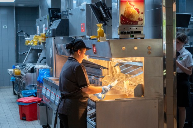 Kitchen staff work at a newly opened fast food restaurant in a former McDonald's outlet in Bolshaya Bronnaya Street in Moscow, Russia, Sunday, June 12, 2022. The first of former McDonald's restaurants is reopened with new branding in Moscow. The corporation sold its branches in Russia to one of its local licensees after Russia sent tens of thousands of troops into Ukraine. (AP Photo/Dmitry Serebryakov)