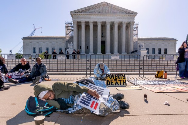 Activists demonstrate at the Supreme Court as the justices consider a challenge to rulings that found punishing people for sleeping outside when shelter space is lacking amounts to unconstitutional cruel and unusual punishment, on Capitol Hill in Washington, Monday, April 22, 2024. (AP Photo/J. Scott Applewhite)