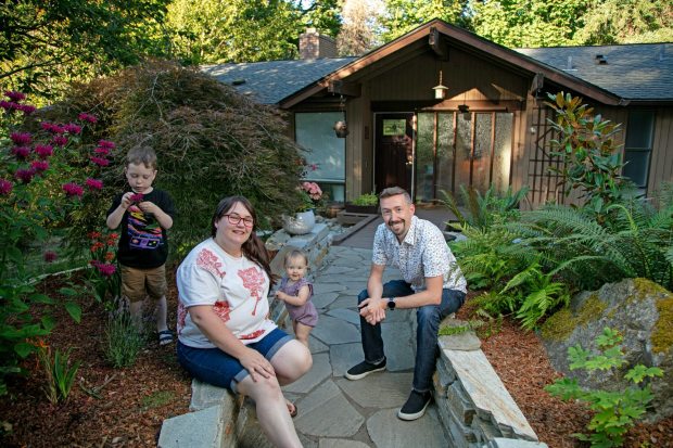 Christine Stephens, left, and her husband, Blake, with their children in front of their home in Bellevue, Washington, on Thursday, August 3, 2023. The Stephens moved from Fremont, Calif., to a five-bedroom, three-bath, 3,000-square-foot house with huge windows overlooking a green preserve with 50-foot pine trees and big-leaf maples in Eastgate neighborhood just outside Seattle. (Photo by John Lok for Bay Area News Group)