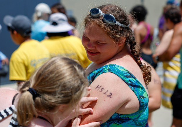 Ashlynn Bull, of Palo Alto Thunder, has her number checked before a swim completion by teammate Anneli Rullo for the Special Olympics Northern California 2024 Cupertino Spring Games at Cupertino High School in Cupertino, Calif., on Saturday, May 18, 2024. (Shae Hammond/Bay Area News Group)