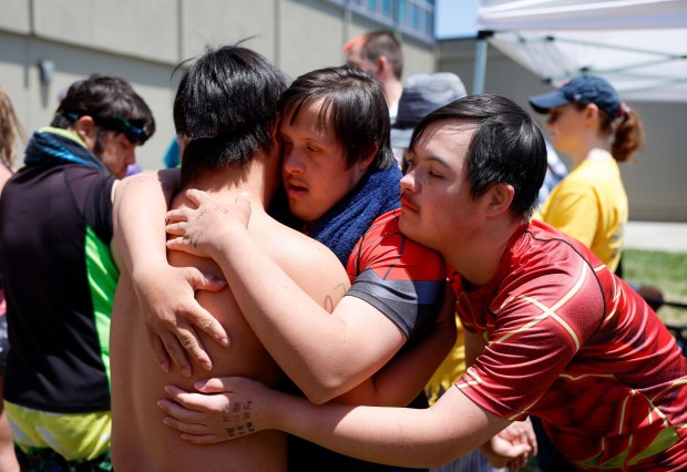 (Left to right) Jacob Bourdon, Gabriel Griffith, and Kamden Kim, teammates and friends on a team from Santa Clara, hug during the Special Olympics Northern California 2024 Cupertino Spring Games at Cupertino High School in Cupertino, Calif., on Saturday, May 18, 2024. (Shae Hammond/Bay Area News Group)