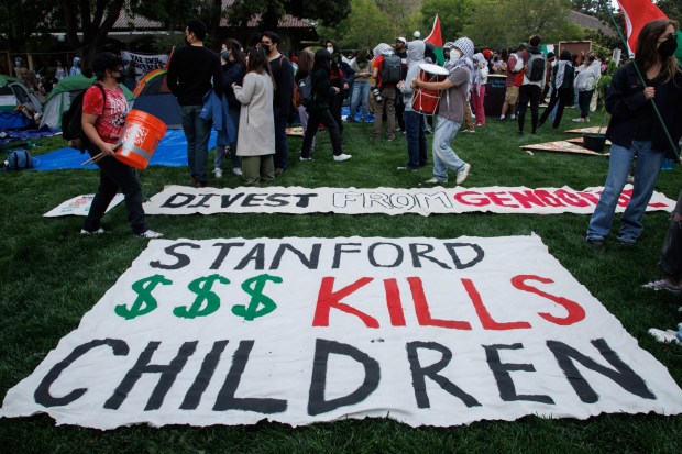 Banners are displayed by the tents pitched at Stanford University's White Plaza during a protest urging the university to divest from Israel and demanding a permanent cease-fire in the war in Gaza, on Thursday, April 25, 2024, at Stanford University. (Dai Sugano/Bay Area News Group)