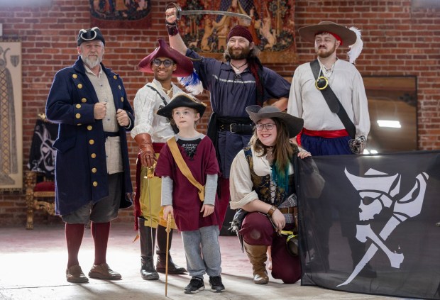 Steaphen Fick, left, founder of the Davenriche European Martial Arts School, offers James, a 7-year-old Make-a-Wish child, a chance to be a pirate, Friday, March 24, 2023, in San Jose, Calif. The school, created more than 20 years ago in San Jose, returned back to the city after years in Santa Clara. (Karl Mondon/Bay Area News Group)